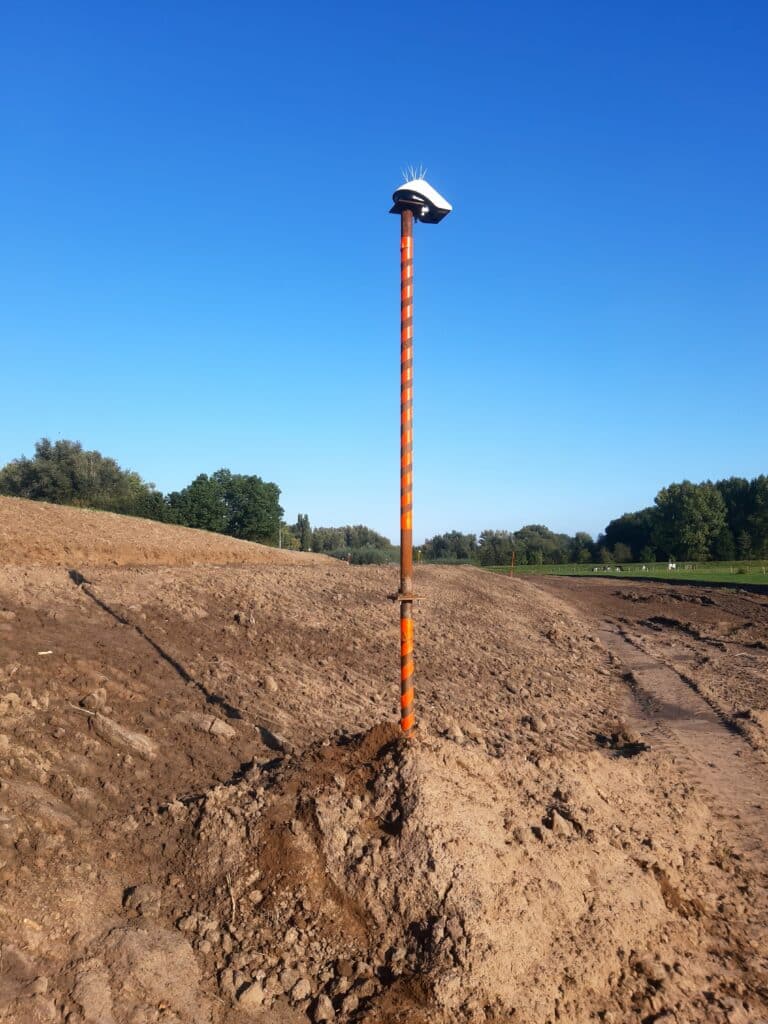 Locator Ones on the shores of Germany. Locator One, Basetime's autonomous measurement device, on a survey marker for precise soil settlement measurements